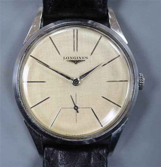 A gentlemans stainless steel Longines manual wind wrist watch, with baton numerals and subsidiary seconds,